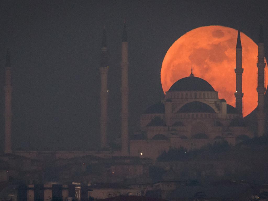 A Super Blue Blood Moon rises behind the Camlica Mosque on January 31, 2018 in Istanbul, Turkey. A Super Blue Blood Moon is the result of three lunar phenomena happening all at once: not only is it the second full moon in January, but the moon will also be close to its nearest point to Earth on its orbit, and be totally eclipsed by the Earth’s shadow. The last time these events coincided was in 1866, 152 years ago. Picture: Chris McGrath/ Getty