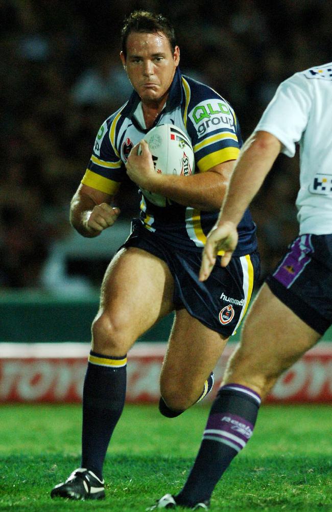 25 Mar 2006 MandatoryCredit PicCameron/Laird: Nth Qld Cowboys vs Melbourne Storm @ Dairy Farmers Stadium: Cowboys' Matthew (matt) Scott runs at Antonio Kaufusi (L) and Garrett Crossman (R)