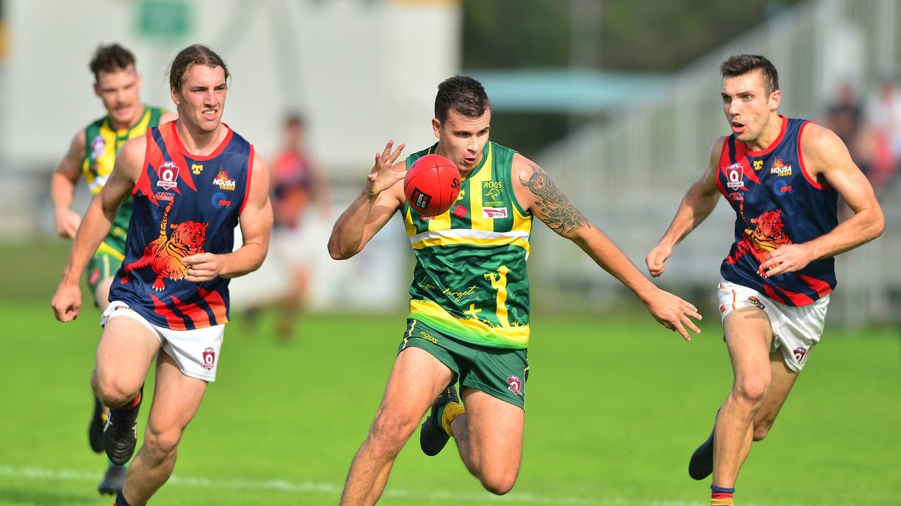 AFL action at Maroochydore between Maroochydore and Noosa. Mitchell Scholard evades two Tigers.