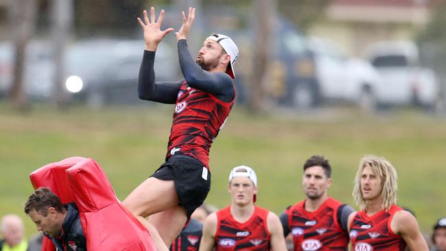 Cale Hooker flies high at Essendon training. Picture: Michael Klein