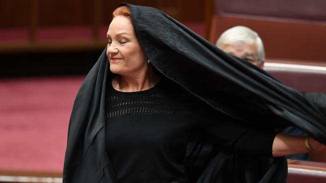 Pauline Hanson removes her burqa during Senate Question Time. Picture: AAP