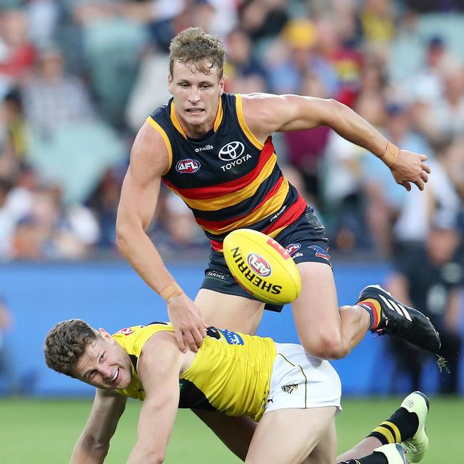 Crows captain Jordan Dawson tries to climb over Jacob Hopper to win the ball.