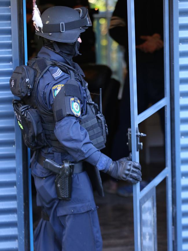 A police officer during a raid on the home of a suspected bikie associate in northern NSW. Picture: NSWPF