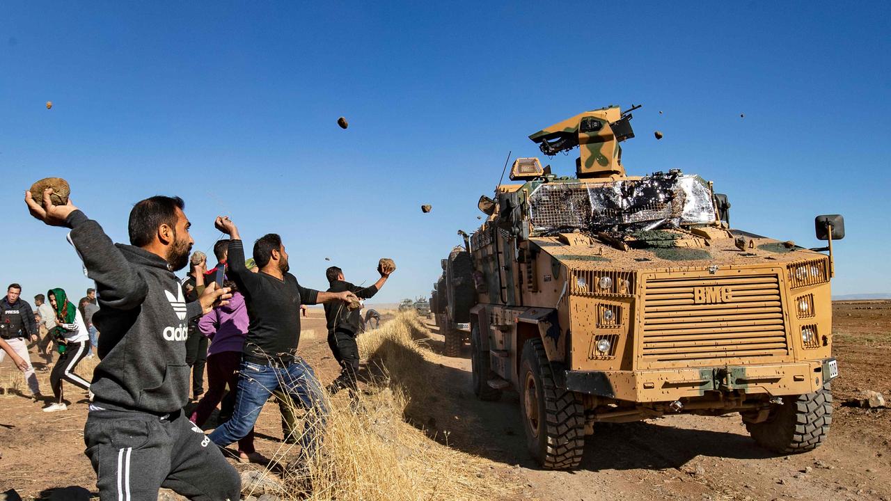 Kurdish demonstrators hurl rocks at a Turkish military vehicle in November 2019. Picture: Delil Souleiman/AFP