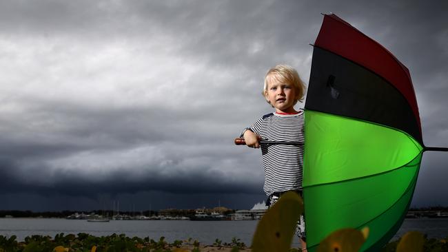 Heavy rain is forecast for the next couple of days. Two-year-old James Adsett gets prepared on the Gold Coast as storms roll in. Pics Adam Head