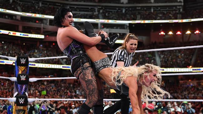 Rhea Ripley gets the upper hand over Charlotte Flair as they grapple in the ring. Picture: WWE