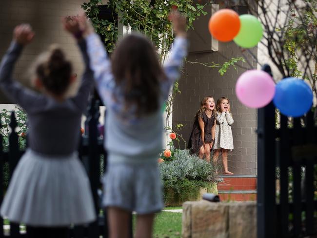 Sisters Lucy and Sophia Held decorated their friend and neighbours Violet and Fleur Thompson’s front fence to celebrate Violet’s fourth birthday. Picture: Christian Gilles