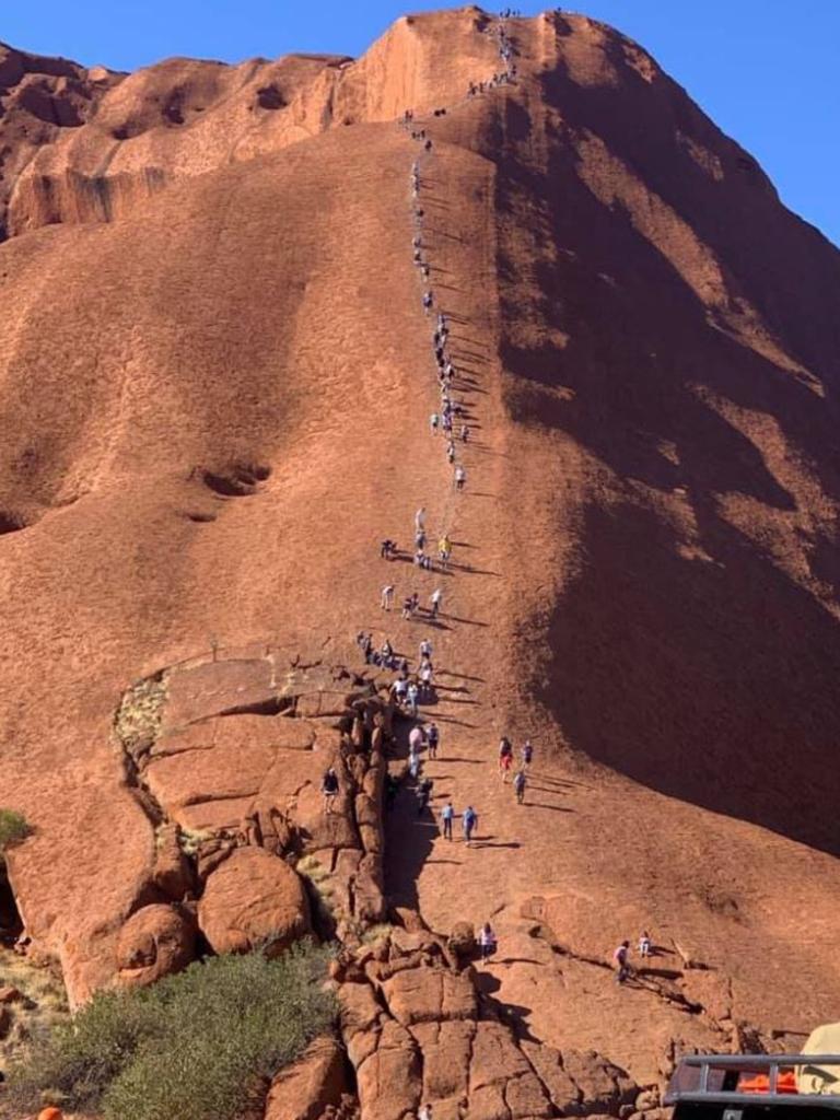 A photo of tourists climbing Uluru has left traditional landowners furious. Picture: ABC