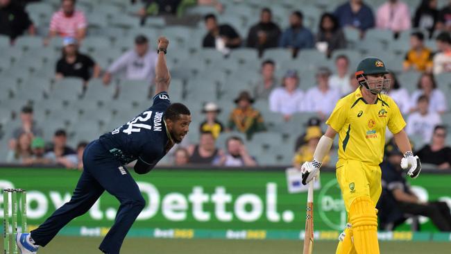 England's Chris Jordan bowls past Australia's Travis Head during the first one-day international (ODI) cricket match between Australia and England at the Adelaide Oval on November 17, 2022 in Adelaide. (Photo by Brenton Edwards / AFP) / -- IMAGE RESTRICTED TO EDITORIAL USE - STRICTLY NO COMMERCIAL USE --