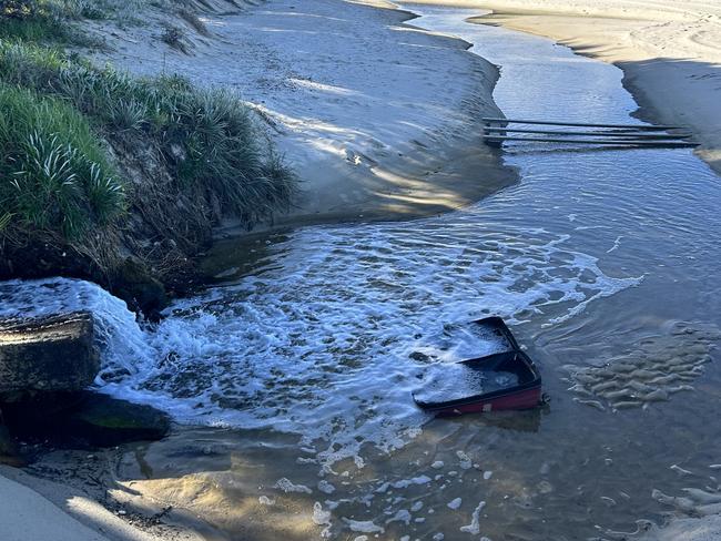 The water is dumped into the ocean on Lady Robinson beach in Brighton. Picture: Tileah Dobson