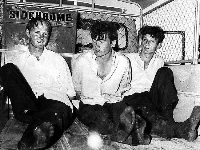 Prison escapees (from left) Terrence Haley, Raymond Gunning and Murray Andrew Brooks handcuffed in back of truck after their capture on Birdsville Track.