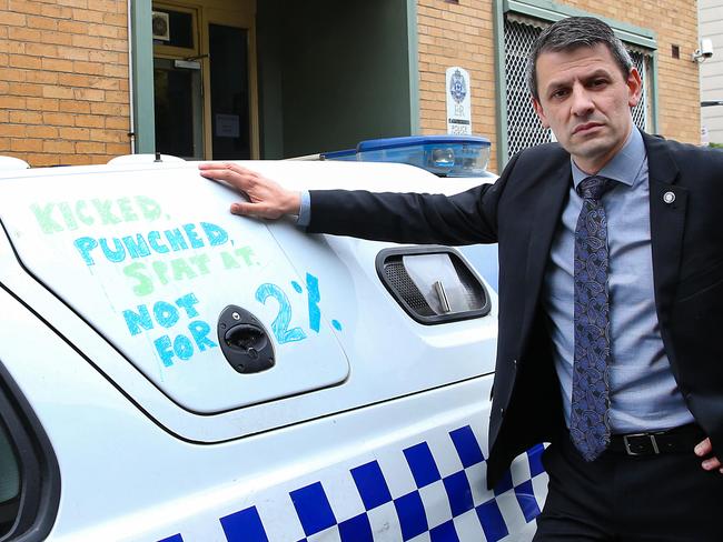 Victoria Police taking industrial action in wage dispute.Police Association Victoria Secretary Wayne Gatt with a police car promoting the actions of the union.Picture : Ian Currie