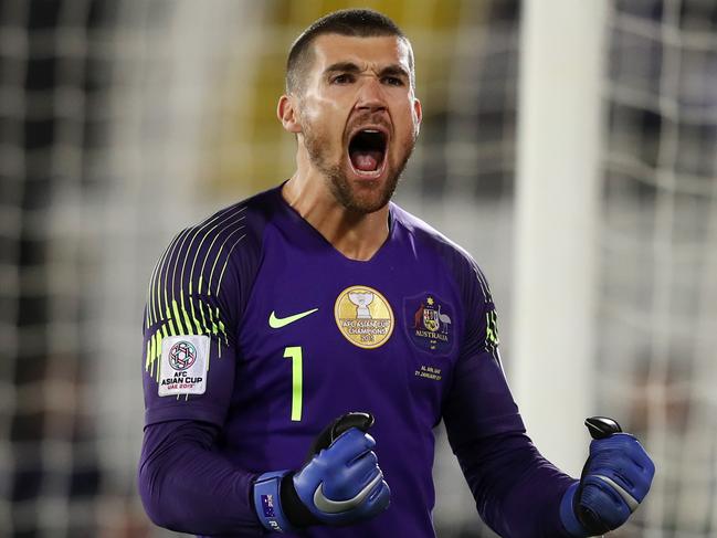 AL AIN, UNITED ARAB EMIRATES - JANUARY 21: Mat Ryan of Australia celebrates after saving the fourth penalty from Marat Bikmaev of Uzbekistan (not pictured) in the penalty shoot out during the AFC Asian Cup round of 16 match between Australia and Uzbekistan at Khalifa Bin Zayed Stadium on January 21, 2019 in Al Ain, United Arab Emirates. (Photo by Francois Nel/Getty Images)