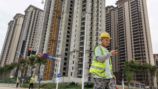 A worker walks past a housing complex under construction by Chinese property developer Evergrande in Wuhan, in China's central Hubei province on September 28, 2023. Picture: AFP