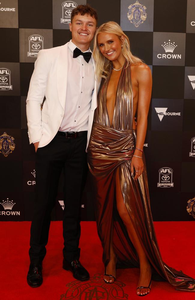 Jack Ginnivan’s guest Lily Mitchell opted for a gold dress that had a plunging neckline down to her navel and a dramatic thigh-high split.. Picture: NewsWire/ Michael Klein