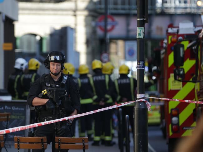 Armed British police officers stand on duty outside Parsons Green underground tube station. Picture: AFP