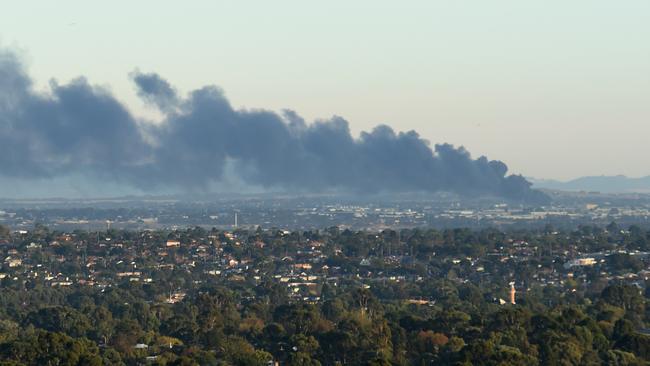 The fire sent thick black smoke across Melbourne's north. Picture: Tony Gough