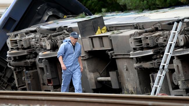 Police investigate the scene of last night's fatal derailment near Wallan. Picture: Andrew Henshaw