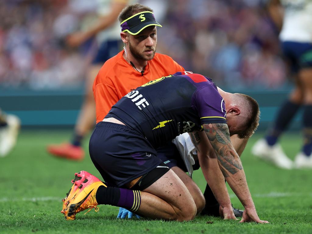 BRISBANE, AUSTRALIA - MAY 19: Cameron Munster of the Storm receives attention from the trainer during the round 11 NRL match between Melbourne Storm and Parramatta Eels at Suncorp Stadium, on May 19, 2024, in Brisbane, Australia. (Photo by Hannah Peters/Getty Images)