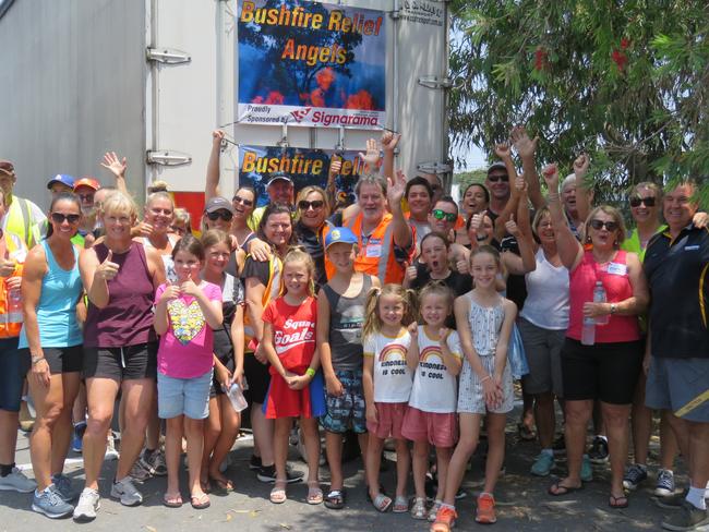 Some of the many volunteers who have been busy sorting and packing donated items bound for NSW South Coast bushfire victims take a break before farewelling the first of two semi trailers which left the Tweed this week.