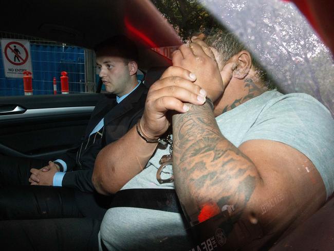 Richard Ene is taken into police custody. Picture: Mark Stewart