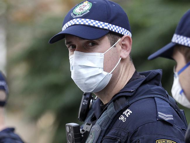 Police stand in front of the Town Hall as protesters gather in Sydney, Saturday, June 13, 2020, during a day of demonstrations across Australia in support of the Black Lives Matter movement and refugee rights. Protesters in Sydney, Adelaide and Perth were urged to stay away by government officials concerned about the risk of spreading the new coronavirus. (AP Photo/Rick Rycroft)