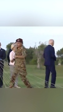 Joe Biden is helped by the Italian Prime Minister after wandering off