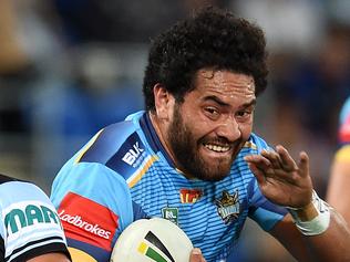 Konrad Hurrell of the Gold Coast Titans (right) is tackled by Gerard Beale of the Cronulla Sharks during their round 21 NRL game at Cbus Super Stadium on the Gold Coast, Monday, Aug. 1, 2016. (AAP Image/Dan Peled) NO ARCHIVING, EDITORIAL USE ONLY