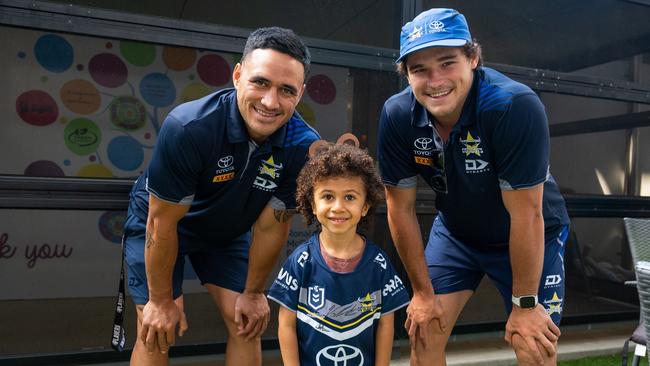 North Queensland Cowboys’ players Valentine Holmes and Tom Chester with young fan Shadrach at Ronald McDonald House in Townsville. The NRL club in conjunction with Sun Metals has launched a new Cowboys in Capes program to support patients at Townsville University Hospital and RMH. Picture: Supplied