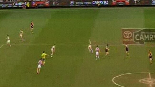 Joel Selwood and Patrick Dangerfield are almost within touching distance of Trent Cotchin after he earns a free kick.