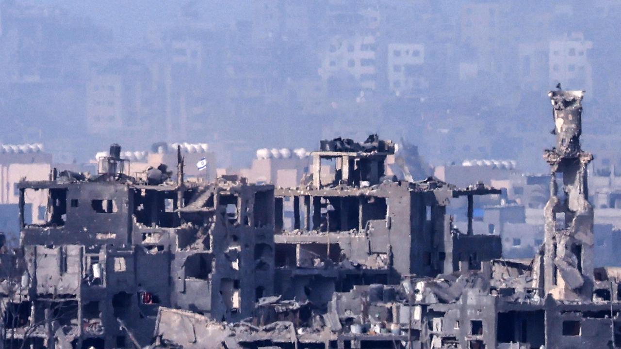 An Israeli flag flying over destroyed buildings in the Palestinian enclave, amid ongoing battles between Israel and the Palestinian Hamas movement. Picture: AFP