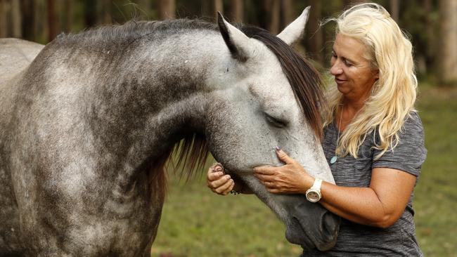 Natalie Skillings-Smith from Woodburn is reunited with her Arabian warm blood, Centaur, who survived the floods in Woodburn swimming in neck-high waters for more than ten hours. Picture: Jonathan Ng