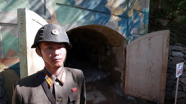 A North Korean soldier stands at the entrance to a tunnel at the Punggye-ri nuclear test site on May 24, 2018 in Punggye-ri, North Korea.