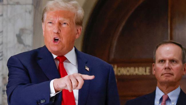 Former US president Donald Trump speaks to members of the media during the third day of his civil fraud trial in New York on October. At the crux of the case is Mr Trump’s habit of overstating the value of his properties to secure larger loans against them. Picture: AFP