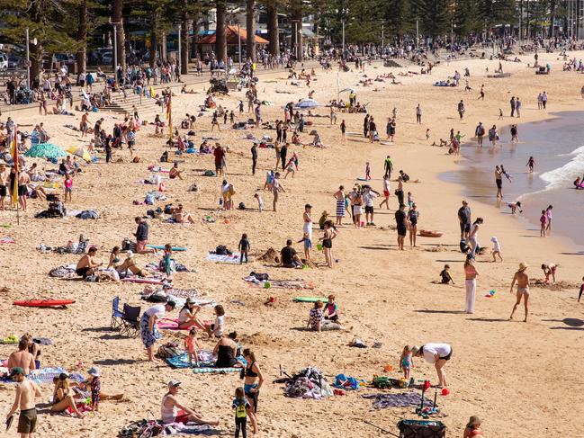 People relax at Manly Beach on Sunday. Photo by Cassie Trotter/Getty Images