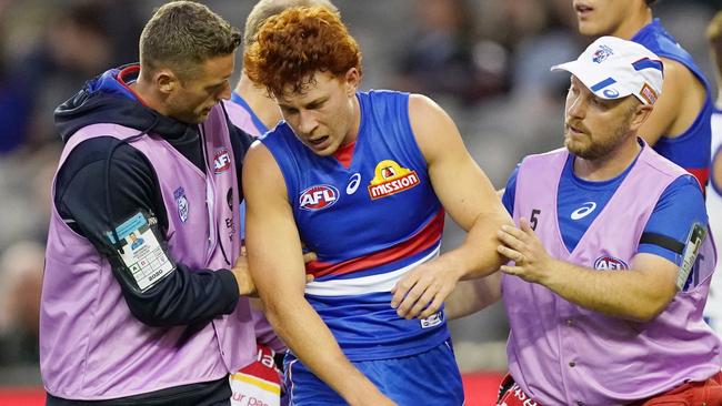 Ed Richards is helped from the field after the hit from Marley Williams. Picture: AAP Images