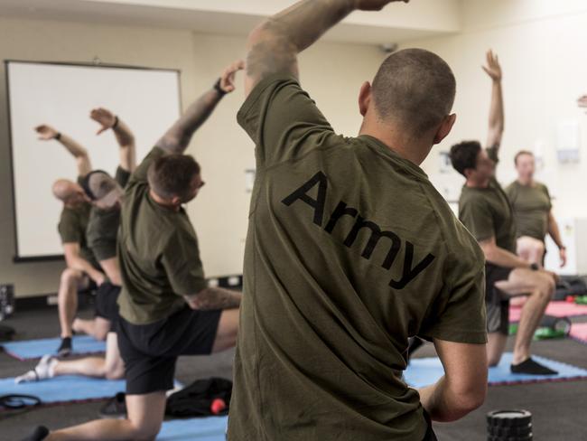 Australian Army soldiers from the Special Operations Training & Education Centre are taken through a stretching session by Australian Institute of Sport staff as part of the human performance optimisation recovery week at the Australian Institute of Sport in Canberra on Tuesday, 05 November 2019. *** Local Caption *** Chief of Army, Lieutenant General Rick Burr, AO, DSC, MVO, and the Special Operations Commander for Australia, Major General Adam Findlay, AM, visited the Australian Armyâ&#128;s newest commando trainees at the Australian Institute of Sport in Canberra on Friday, 08 November 2019.  Around 100 Australian Army soldiers were at the AIS for a one-week human performance optimisation (HPO) recovery week after successfully passing the gruelling three-week-long commando selection course. AIS sports scientists and Army physical training instructors spent the week taking the commando trainees through the theory and practice of strength conditioning, good nutrition, preparation and recovery techniques as part of the HPO recovery week. Armyâs HPO program underpins Chief of Armyâs âArmy in Motionâ strategic guidance to ensure Australian Army personnel are ready for any task now and into the future. The HPO program is about investing in the preparedness and potential of our people: producing skilled and resilient soldiers; empowered, decisive and thoughtful leaders; and cohesive and adaptive teams. Special Operations Education & Training Centre (SOTEC) integrates HPO into all its activities to ensure understanding of the mental, physiological and nutritional aspects of human performance to enable behaviour change and achieve optimal day-to-day performance. Special Operations Command Education & Training Centre (SOTEC) is the Australian Armyâ&#128;s special operations âschoolhouseâ, responsible for Special Operations Commandâs recruitment, selection, training, education and trade management.