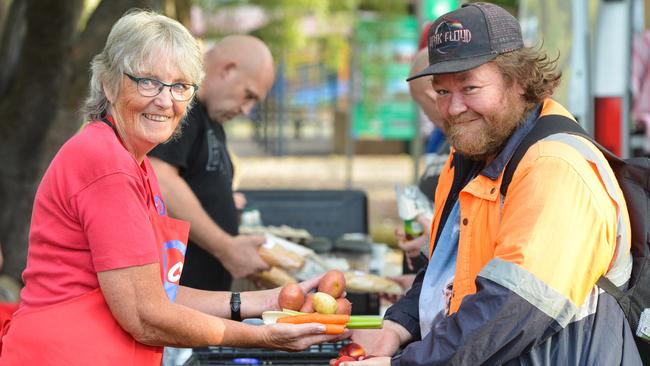 Elizabeth Park local Glen Barnes with Cos We Care founder Ann Cooper with some fresh food in Freemont Park. Picture: AAP/Brenton Edwards