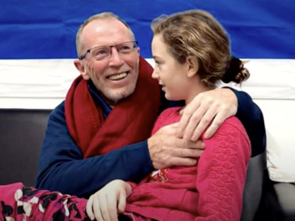 Hostage Emily Hand is reunited with her father Thomas. Picture: 9 News