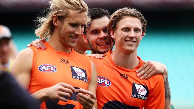 Zac Williams has a laugh with Nick Haynes and Lachie Whitfield.