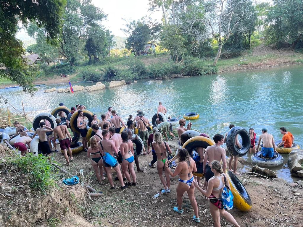 Hundreds of backpackers each afternoon stop at bars like this along the river as they float down in old tyre inners. It’s known as tipsy tubing. Picture: Supplied