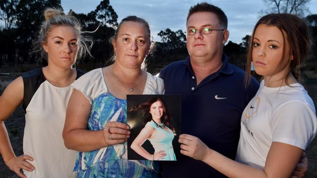 Grieving parents Jane and Michael Cleland with Jess's sister Amy (left) and her best friend Sally (right) holding a photo of Jess. Picture: Jay Town