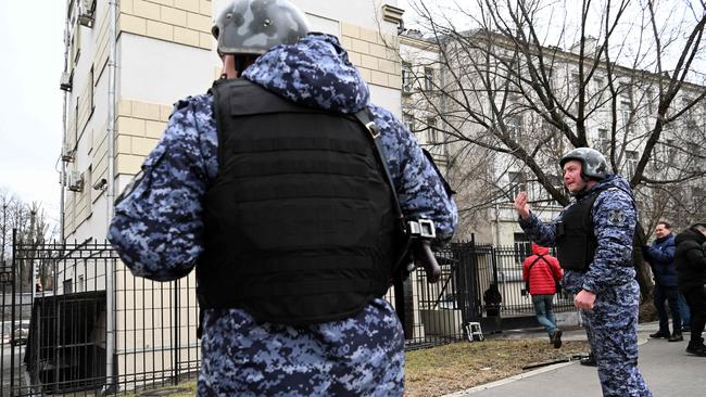 A Russian law enforcement officer gestures outside the Lefortovsky court after Evan Gershkovich was detained. Picture: AFP