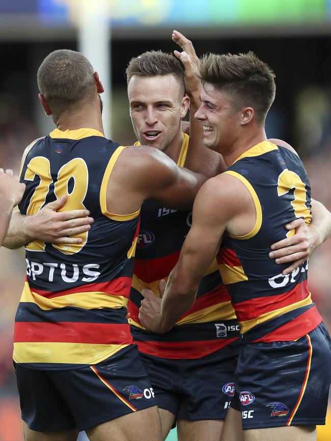 Brodie Smith celebrates his goal in his 150th game with Cameron Ellis-Yolmen and Riley Knight back in April this year. Picture: SARAH REED