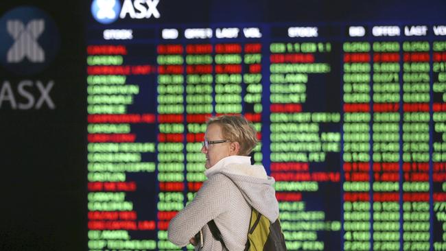 A woman looks at display boards at the Australian Stock Exchange in Sydney. Pic: AP