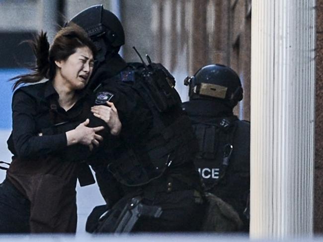 A hostage runs to safety during the Lindt siege. Picture: Chris McKeen