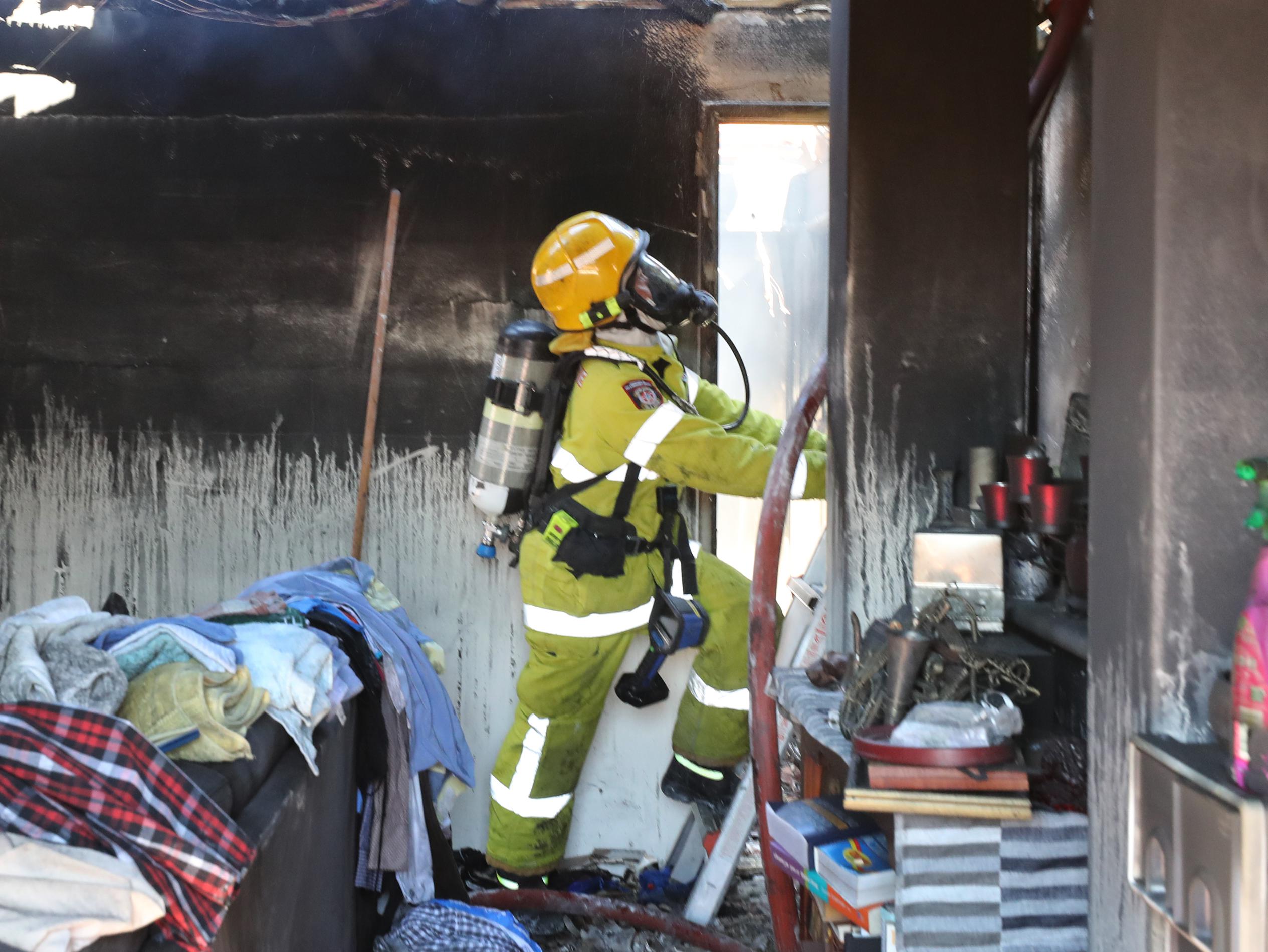 Fire fighters at the scene of a unit fire on the corner of Wanneroo Road and North Beach Road, Tuart Hill.