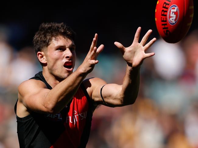 MELBOURNE, AUSTRALIA - MARCH 16: Archie Perkins of the Bombers marks the ball during the 2024 AFL Round 01 match between the Essendon Bombers and the Hawthorn Hawks at the Melbourne Cricket Ground on March 16, 2024 in Melbourne, Australia. (Photo by Dylan Burns/AFL Photos via Getty Images)