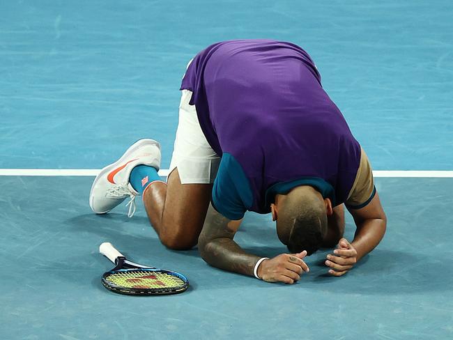 MELBOURNE, AUSTRALIA - FEBRUARY 10: Nick Kyrgios of Australia collapses to the ground after winning his Men's Singles second round match against Ugo Humbert of France during day three of the 2021 Australian Open at Melbourne Park on February 10, 2021 in Melbourne, Australia. (Photo by Mark Metcalfe/Getty Images)