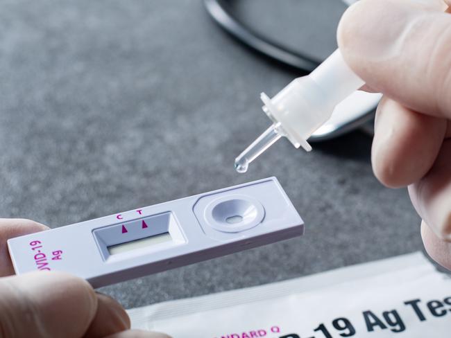 Holding sample tube keep the sample from Nosal cotton bud for a drop to Covid-19 standard q stick for fast test coronavirus in hospital. Home testing kid. Escape 26 March 23. Doc Holiday. Photo - iStock